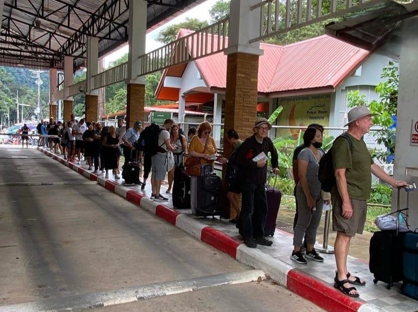 People with luggage waiting single single at a border single single single checkpoint